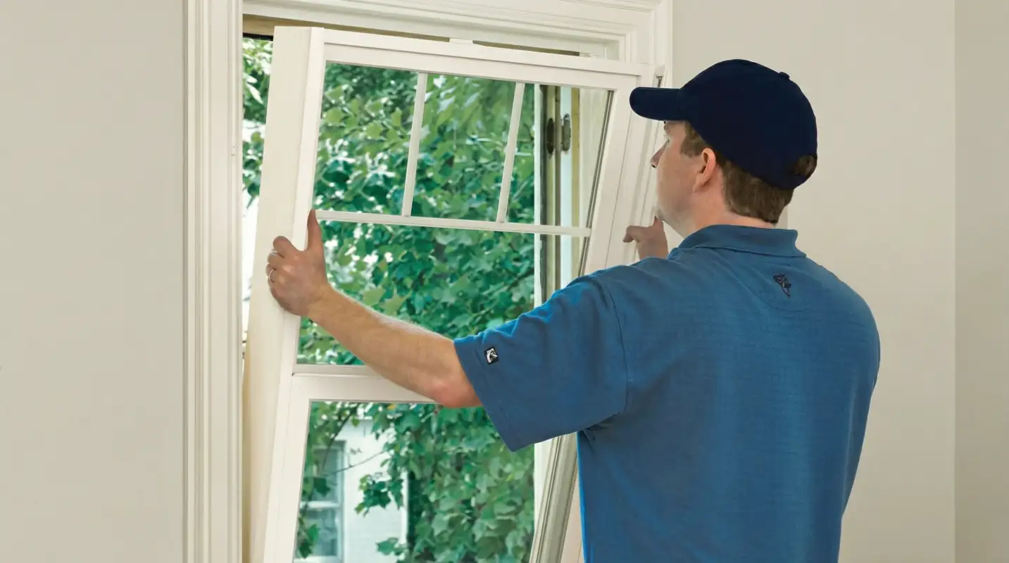 Professional contractors performing a residential window insulation and replacement service in Anchorage, AK